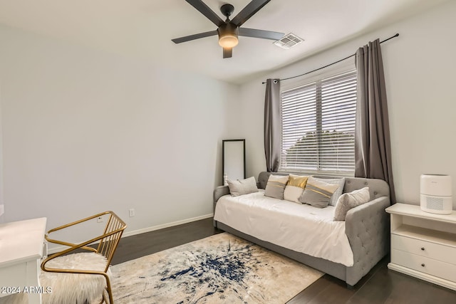 bedroom with dark hardwood / wood-style floors and ceiling fan