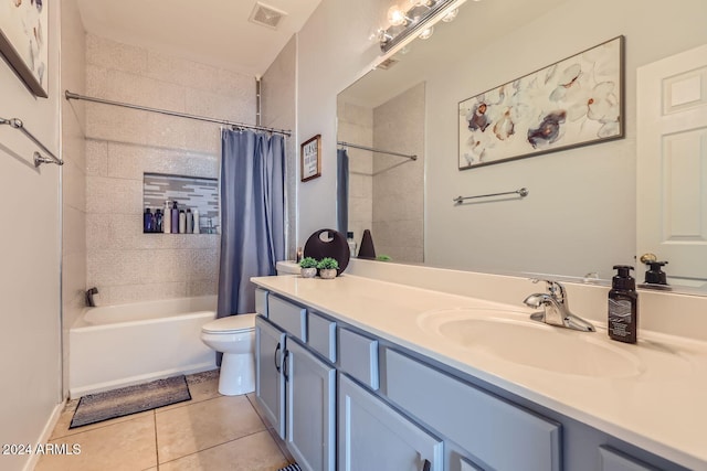 full bathroom featuring toilet, tile patterned flooring, vanity, and shower / tub combo with curtain