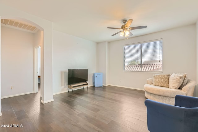 living room featuring ceiling fan and dark hardwood / wood-style floors