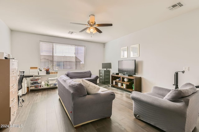 living room featuring ceiling fan and hardwood / wood-style floors