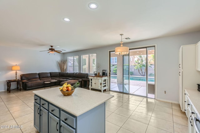 kitchen with decorative light fixtures, ceiling fan, light tile patterned flooring, and a wealth of natural light