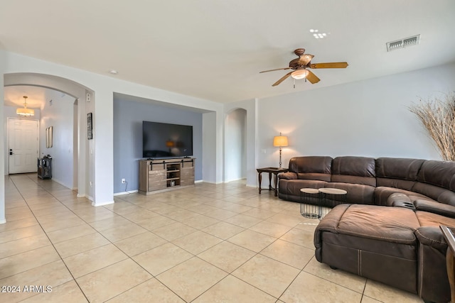 living room featuring ceiling fan and light tile patterned flooring