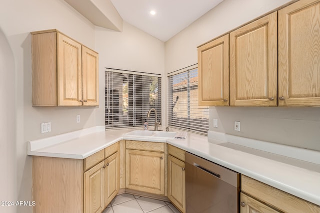 kitchen with dishwasher, light tile patterned floors, sink, and light brown cabinetry