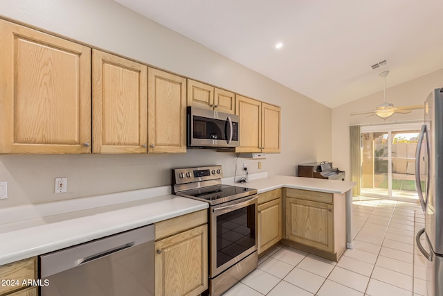 kitchen featuring appliances with stainless steel finishes, vaulted ceiling, ceiling fan, and light brown cabinetry