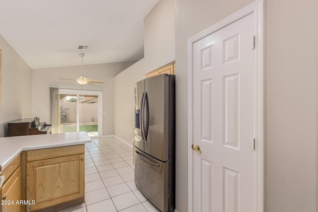 kitchen with lofted ceiling, ceiling fan, stainless steel fridge, light tile patterned floors, and kitchen peninsula