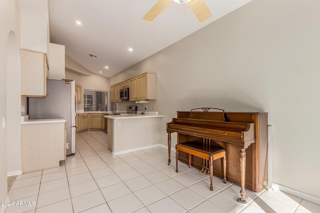 kitchen featuring vaulted ceiling, ceiling fan, light tile patterned floors, kitchen peninsula, and stainless steel appliances