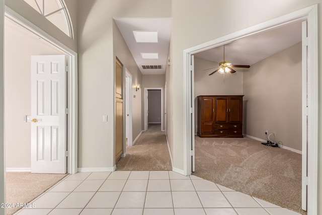 corridor with light colored carpet