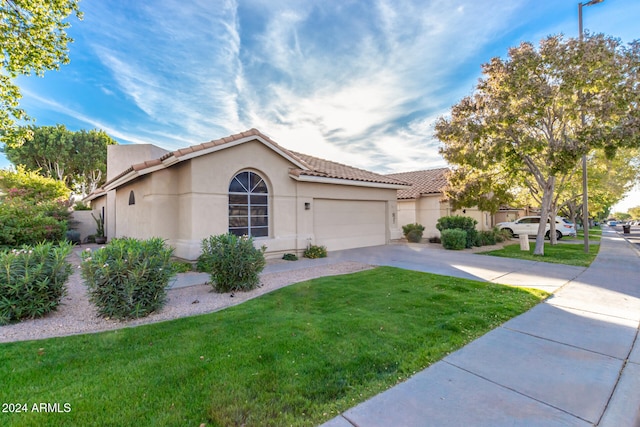 mediterranean / spanish-style home with a garage and a front yard