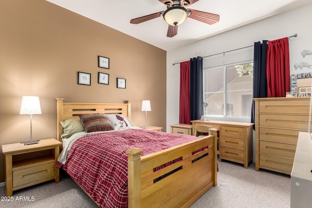bedroom featuring light colored carpet and a ceiling fan