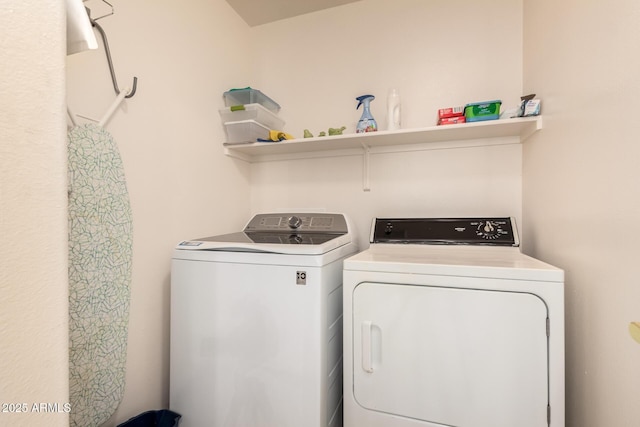 clothes washing area featuring laundry area and washer and clothes dryer