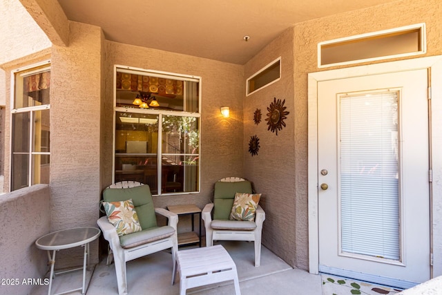 doorway to property featuring stucco siding
