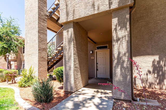 doorway to property with stucco siding