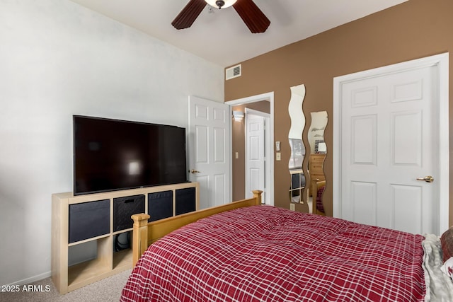 carpeted bedroom with visible vents, baseboards, and a ceiling fan