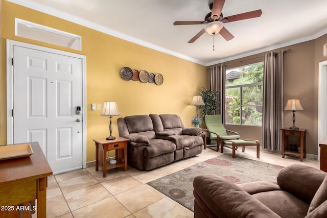 living area with a ceiling fan, baseboards, crown molding, and light tile patterned flooring