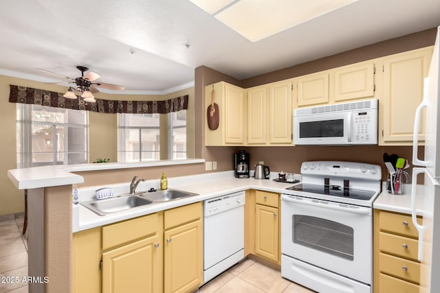 kitchen with ornamental molding, light tile patterned floors, a sink, and white appliances