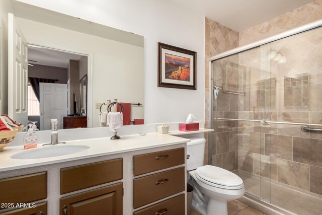 ensuite bathroom with a stall shower, toilet, ensuite bath, tile patterned flooring, and vanity