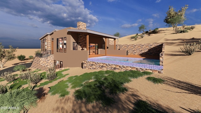 17929 W Estes Way, Goodyear, AZ 85338 - back of house with stone siding, stucco siding, and a chimney