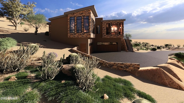 17929 W Estes Way, Goodyear, AZ 85338 - view of front facade with stairway, stone siding, stucco siding, an attached garage, and driveway