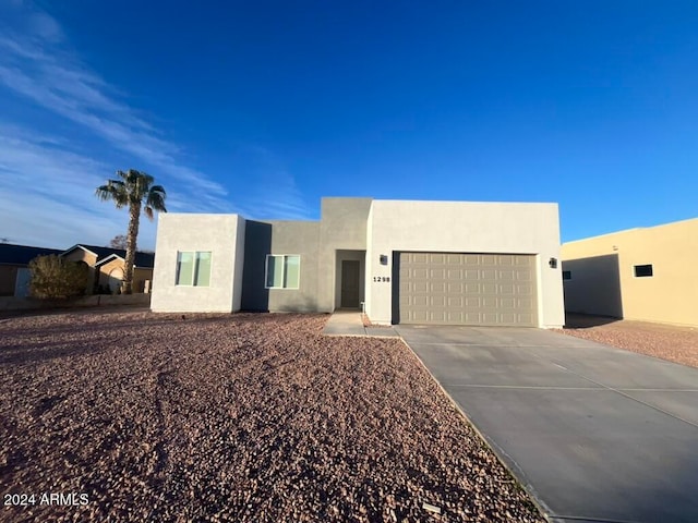 pueblo-style house featuring a garage