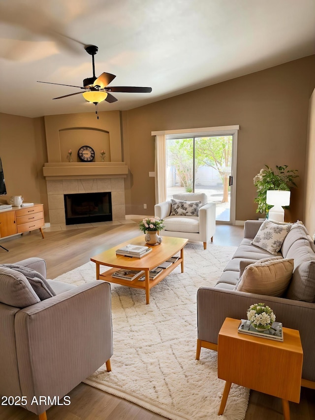 12044 S 45th St, Phoenix, AZ 85044 - living room featuring ceiling fan, wood finished floors, and a tile fireplace