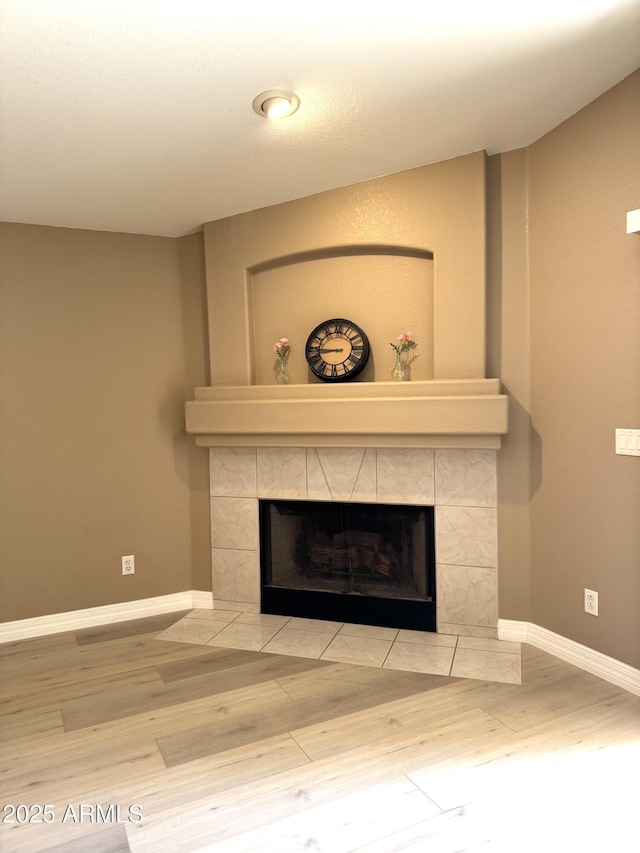 12044 S 45th St, Phoenix, AZ 85044 - detailed view of a tiled fireplace, wood finished floors, and baseboards