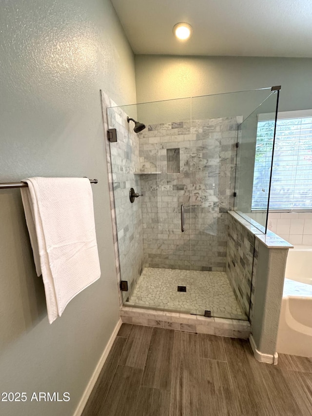 12044 S 45th St, Phoenix, AZ 85044 - bathroom featuring wood finished floors, a shower stall, a garden tub, and baseboards