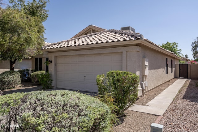 12044 S 45th St, Phoenix, AZ 85044 - view of side of property with stucco siding, a garage, and a tile roof