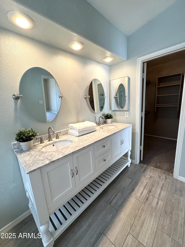 12044 S 45th St, Phoenix, AZ 85044 - full bath with wood tiled floors, double vanity, a spacious closet, and baseboards