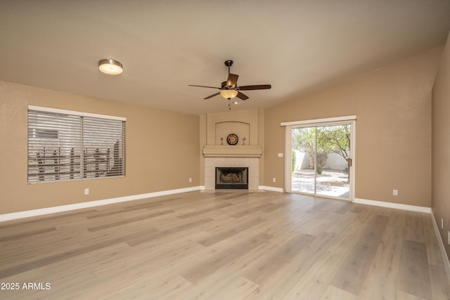 12044 S 45th St, Phoenix, AZ 85044 - unfurnished living room featuring a ceiling fan, a fireplace, baseboards, light wood-style flooring, and lofted ceiling