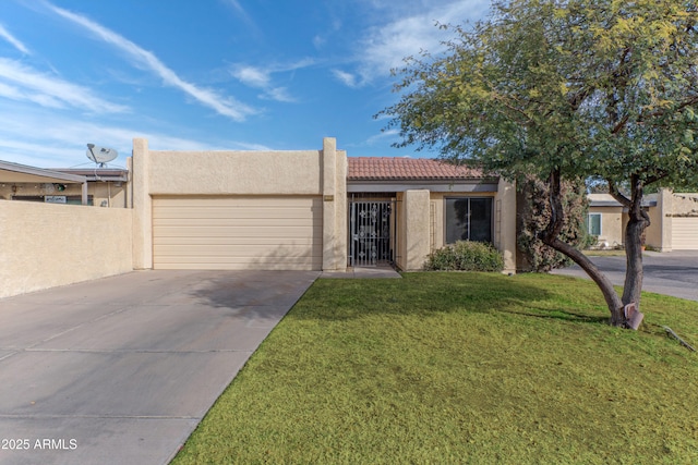 view of front of home featuring stucco siding, an attached garage, a front yard, driveway, and a tiled roof