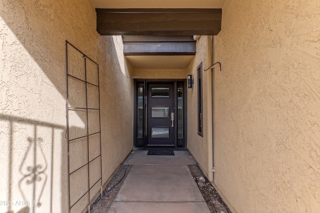 entrance to property with stucco siding