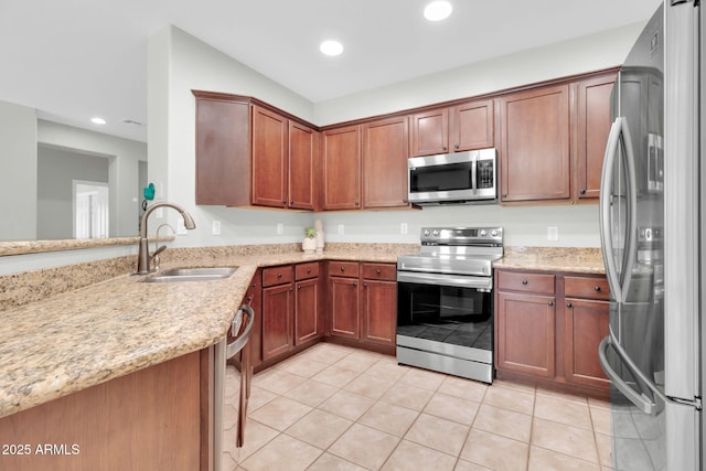 4323 S Ranger Trl, Gilbert, AZ 85297 - kitchen with stainless steel appliances, a sink, light tile patterned floors, light stone counters, and recessed lighting