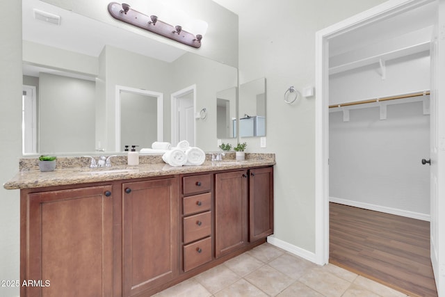 4323 S Ranger Trl, Gilbert, AZ 85297 - bathroom with double vanity, tile patterned floors, baseboards, and a walk in closet