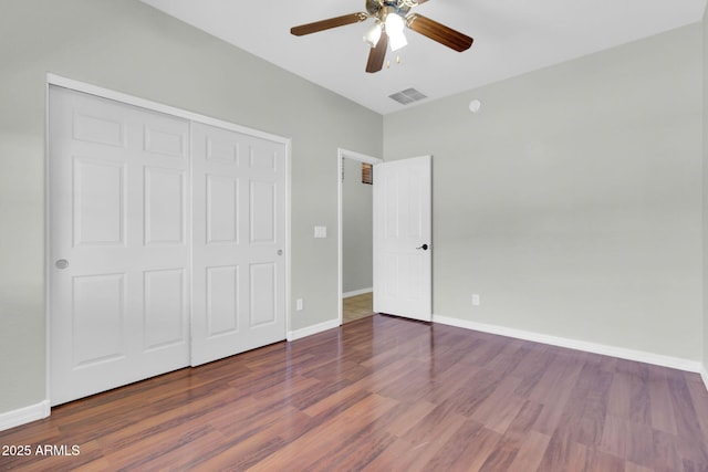4323 S Ranger Trl, Gilbert, AZ 85297 - unfurnished bedroom featuring wood finished floors, baseboards, a closet, and a ceiling fan