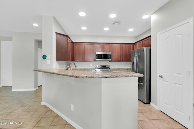 4323 S Ranger Trl, Gilbert, AZ 85297 - kitchen with stainless steel appliances, a peninsula, light stone counters, light tile patterned floors, and a sink