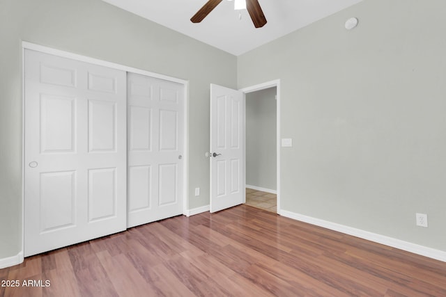4323 S Ranger Trl, Gilbert, AZ 85297 - unfurnished bedroom with wood finished floors, a closet, baseboards, and a ceiling fan