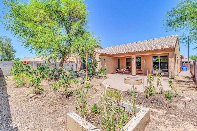 4323 S Ranger Trl, Gilbert, AZ 85297 - rear view of house with a tile roof, a patio area, an outdoor fire pit, a fenced backyard, and stucco siding