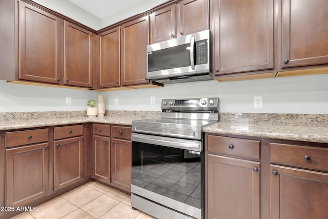 4323 S Ranger Trl, Gilbert, AZ 85297 - kitchen with appliances with stainless steel finishes, light tile patterned floors, and light stone counters