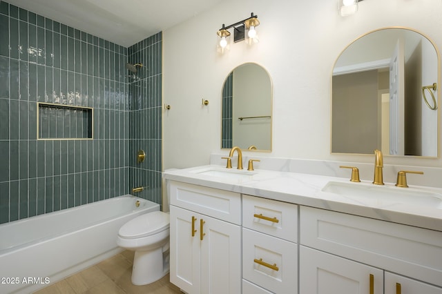 full bathroom with toilet, tile patterned flooring, tiled shower / bath combo, and vanity