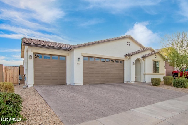 mediterranean / spanish house with a garage