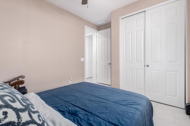 tiled bedroom featuring a closet and ceiling fan