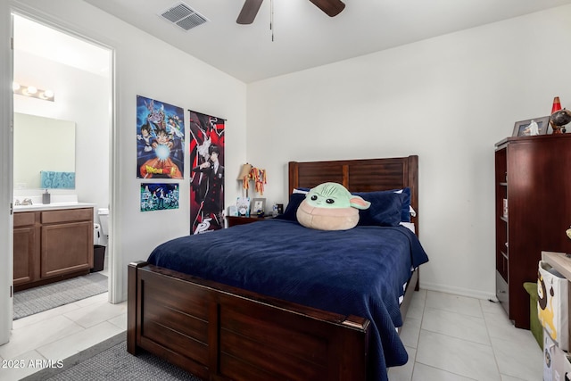 tiled bedroom featuring ceiling fan and ensuite bathroom