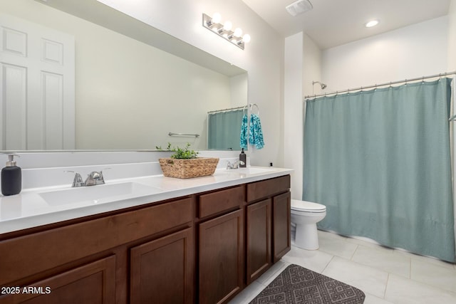 bathroom with vanity, toilet, and tile patterned flooring