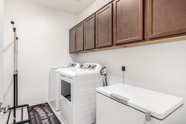 laundry area featuring cabinets and independent washer and dryer