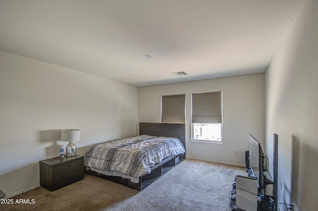 carpeted bedroom featuring visible vents