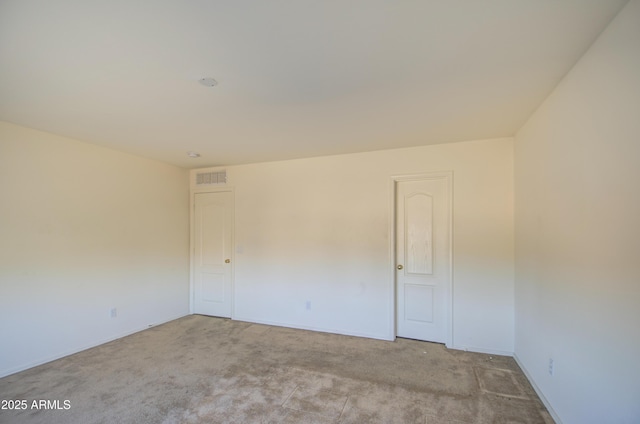 unfurnished room with visible vents, carpet floors, and baseboards