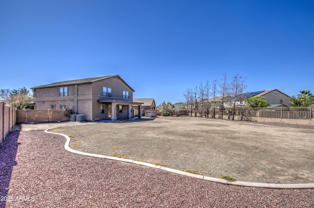 view of yard featuring a fenced backyard and central AC