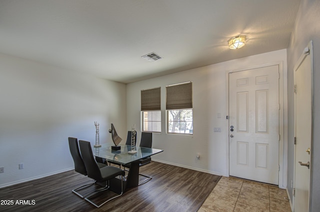 home office featuring visible vents, baseboards, and wood finished floors