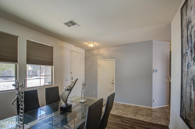 interior space with visible vents, baseboards, and wood finished floors