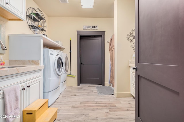5039 S 158th St, Gilbert, AZ 85298 - clothes washing area featuring light wood-style floors, baseboards, a sink, cabinet space, and independent washer and dryer